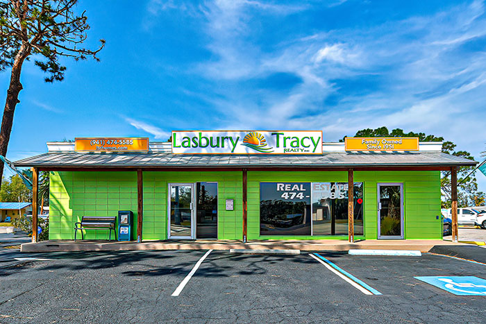 Lasbury Tracy Realty in Englewood Florida - lime green building with orange signage